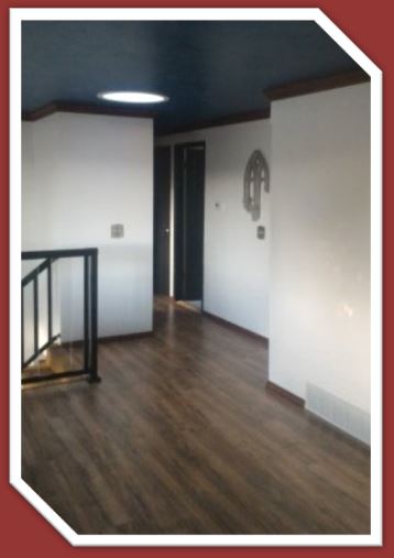 a Lakeshore Pecan laminate floor, installed by Hardwood Floorist in a customer's entry hall.